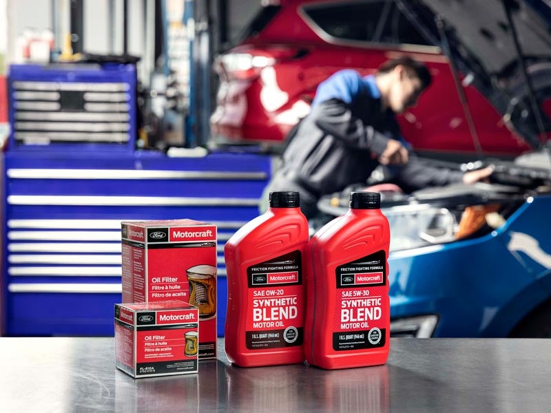 Motorcraft oil filters and synthetic blend motor oil bottles on a workbench in auto shop